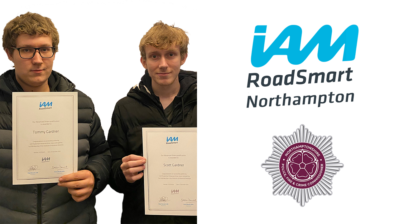 The Gardner brothers holding up their I AM Roadsmart Advanced Driver certificates