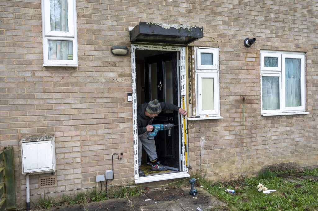 Front door being fitted in the Queensway, Wellingborough