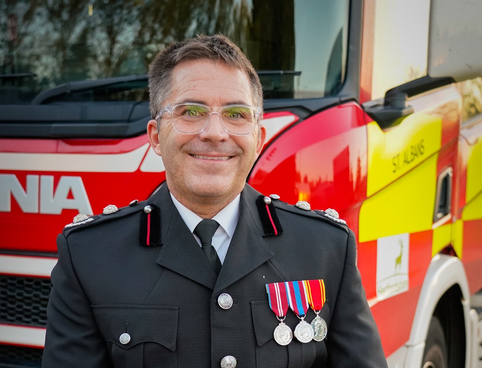 Simon Toohill in front of a fire appliance