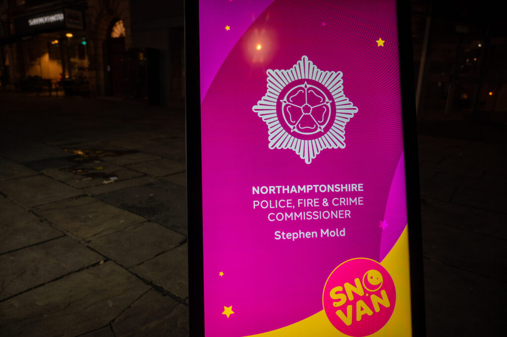 A digital screen, mostly in pink, is shown with the PFCC logo and displaying the words: Northamptonshire Police, Fire and Crime Commissioner Stephen Mold SNOvan