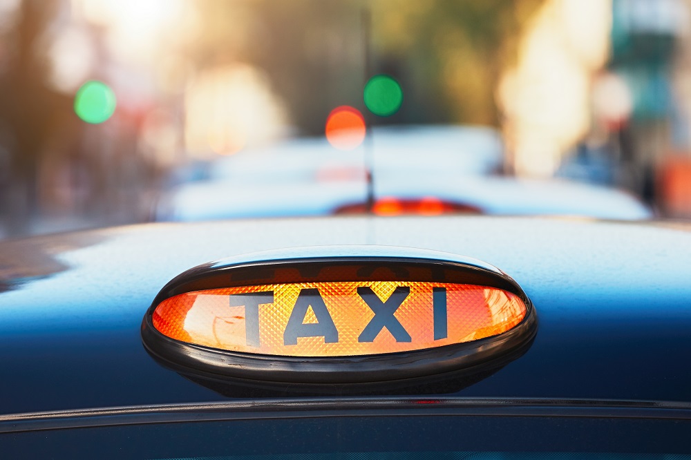 Picture shows the Taxi light in yellow on the top of a black hackney carriage vehicle