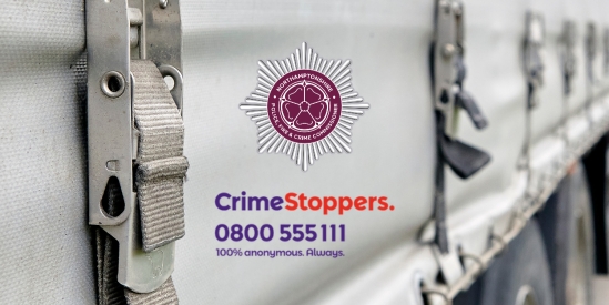 Side curtain of a HGV lorry with strapping. OPFCC logo and Crimestoppers logo