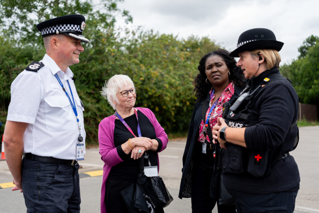 DPFCC Marianne Kimani, PFCC Danielle Stone and Chief Constable Ivan Balhatchet talking to a police officer in Brackley town centre