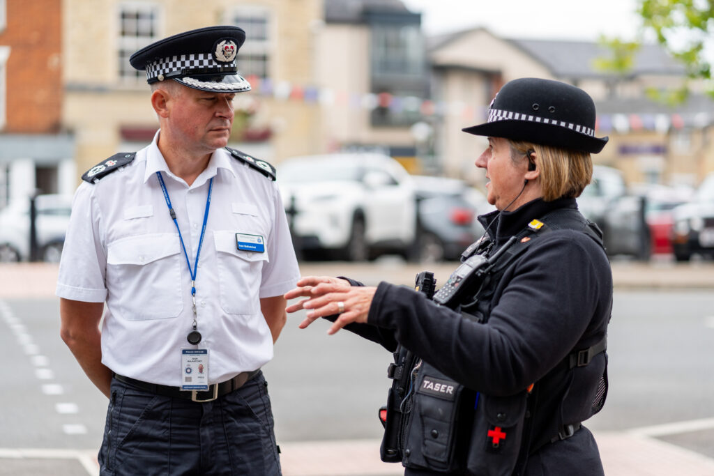 Chief Constable Ivan Balhatchet speaking to a police officer