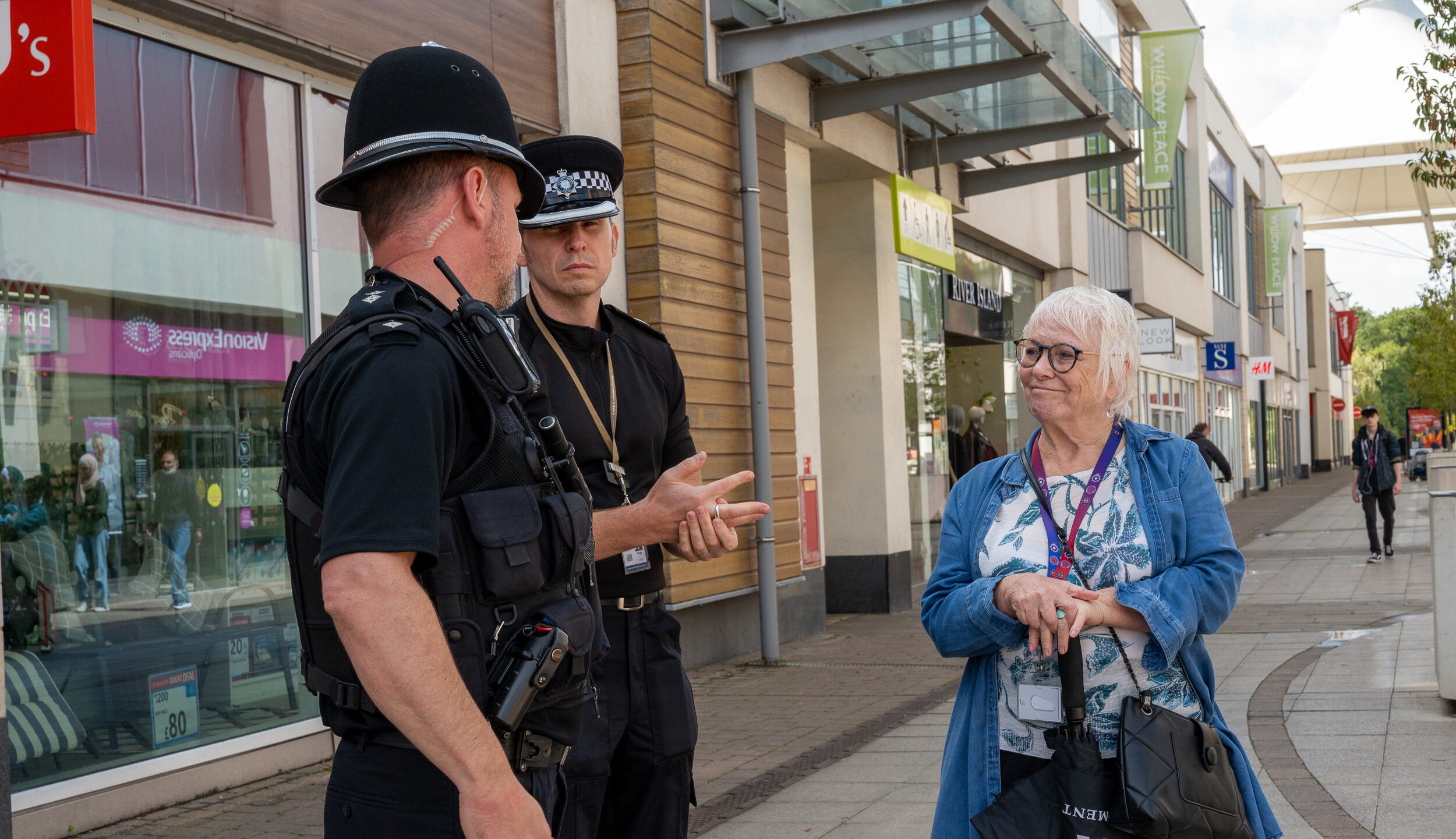 PFCC Danielle Stone stood in Corby Town Centre with two police officers in full uniform