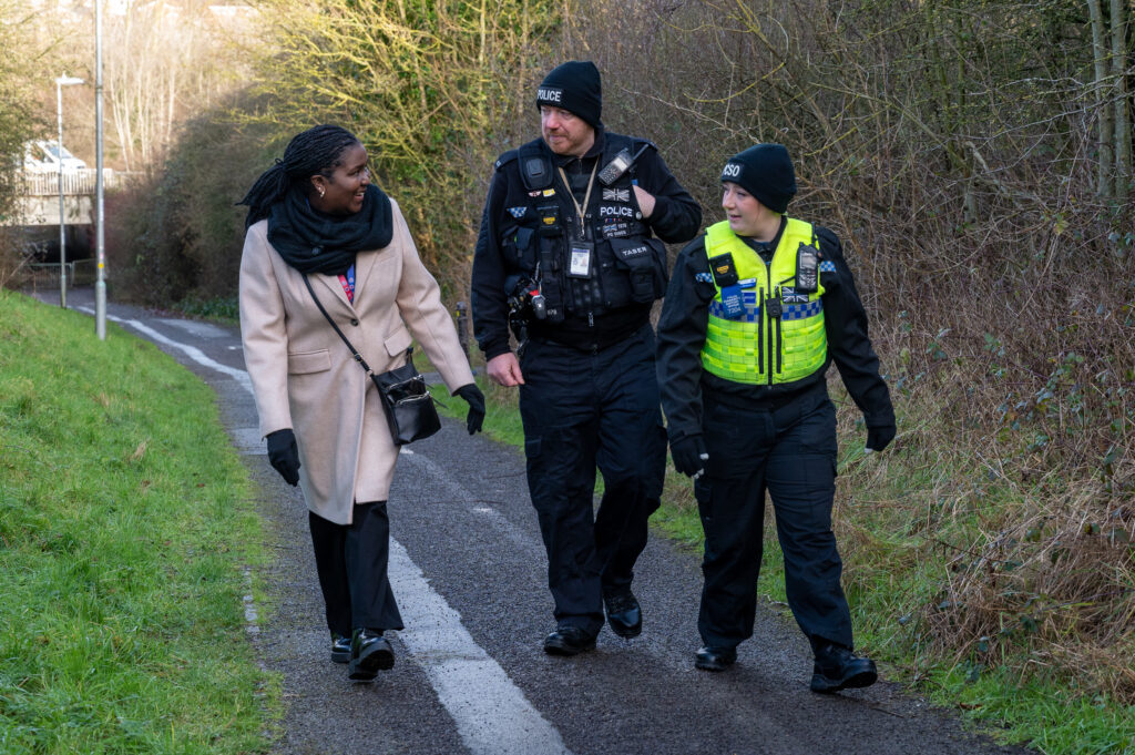 DPFCC Marianne Kimani walking and talking with a police officer and a PCSO