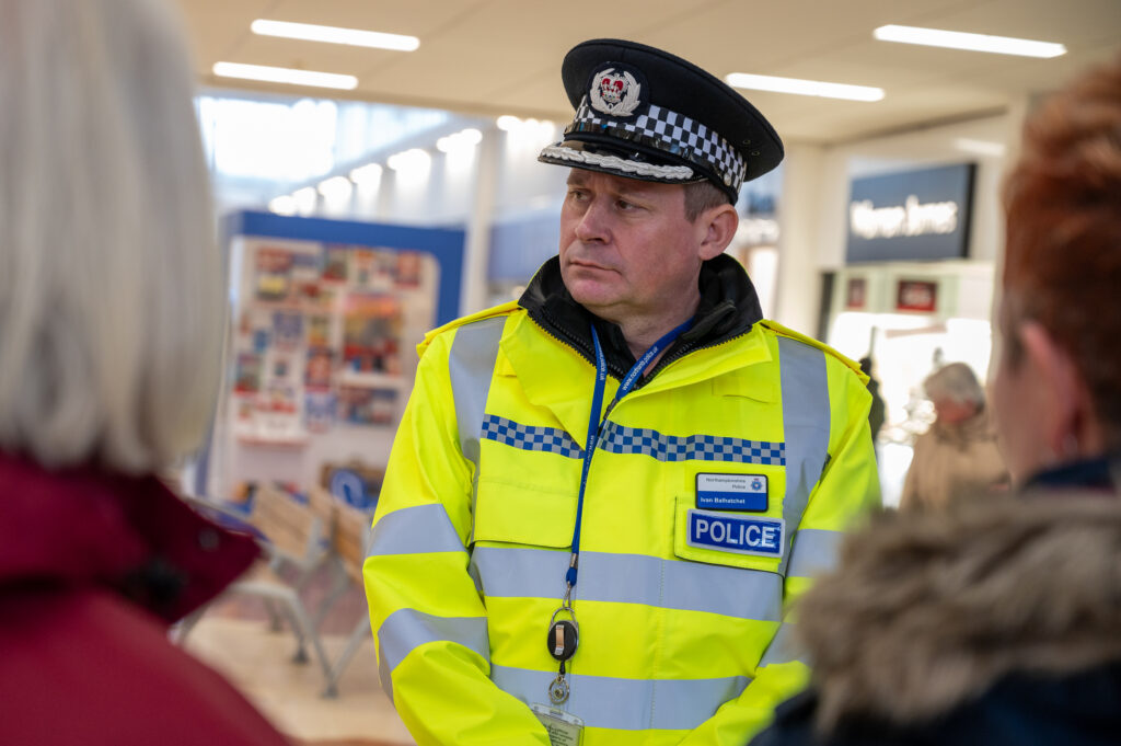 Chief Constable Ivan Balhatchet, shown wearing a yellow high-visibility jacket during a visit to Wellingborough town centre