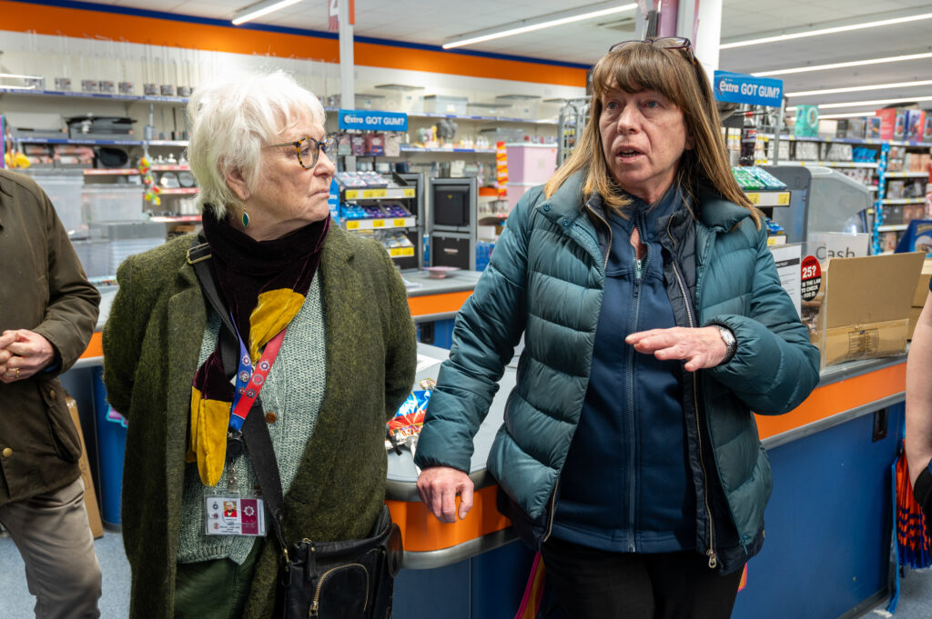 Police Fire and Crime Commissioner Danielle Stone, pictured on the left, is shown facing a store worker in Wellingborough who is wearing a blue coat.