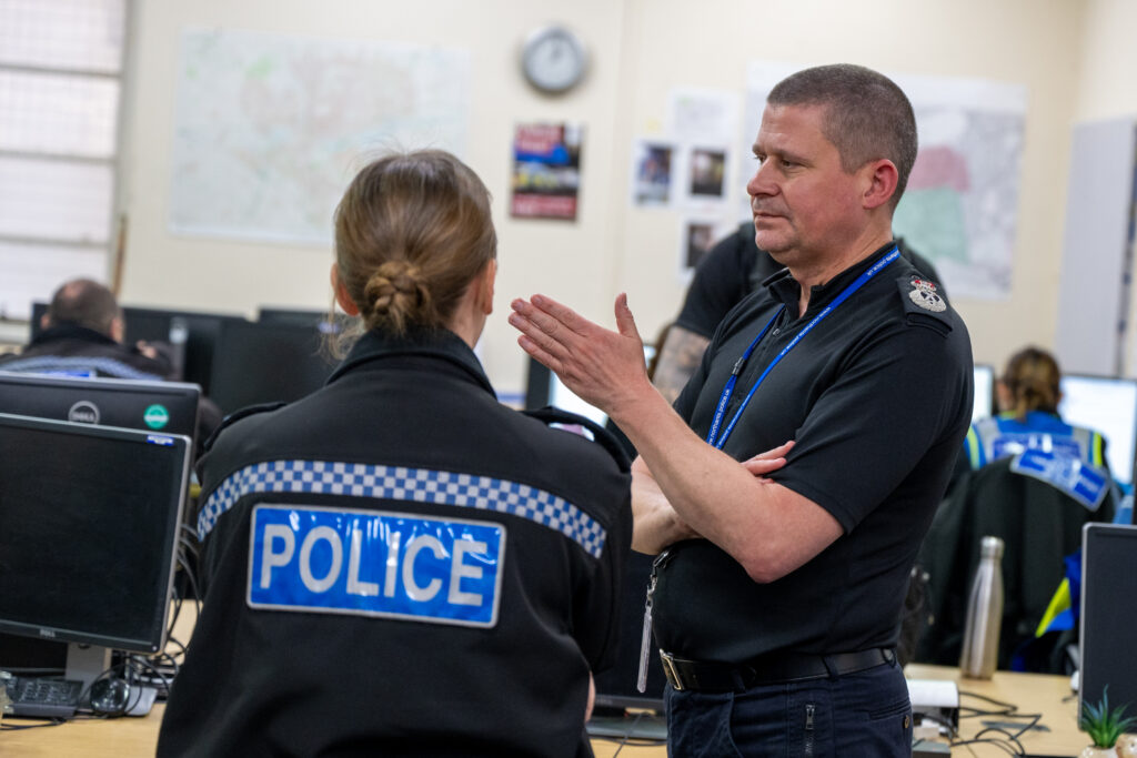 Chief Constable Ivan Balhatchet speaks to a police officer at Campbell Square