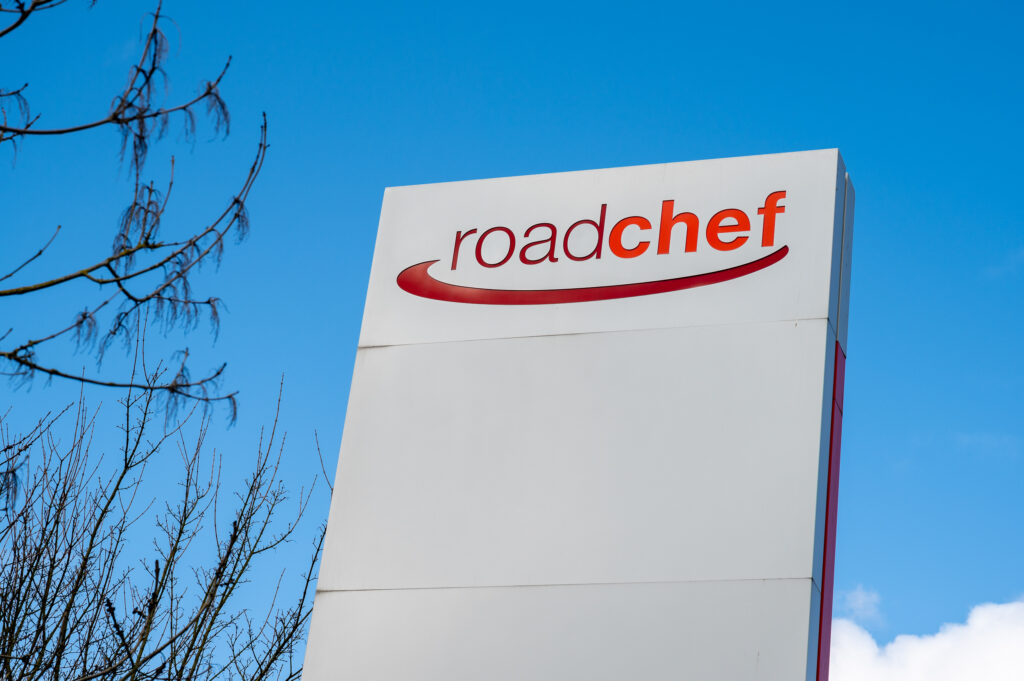 Picture shows a white sign with the words Roadchef written across it in red.