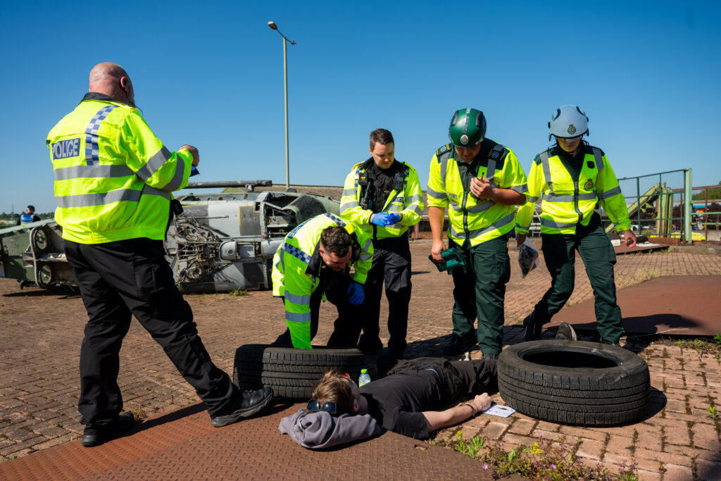 Police and EMAS tend to a fake casualty on scene. 