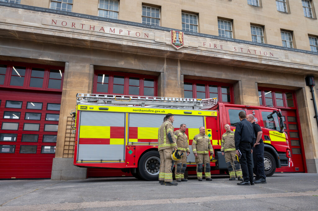 Red Watch crew at the Mounts with Station Commander Andy Luxton and deputy property manager MJ are talking outside the station.
