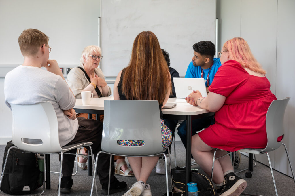 Danielle Stone talking with a table of students