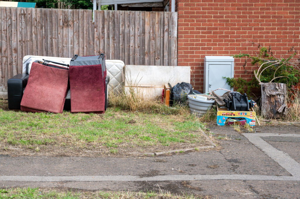 Flytipping - including chairs, sofas and childrens toys dumped on a patch of grass down Newnham Road.