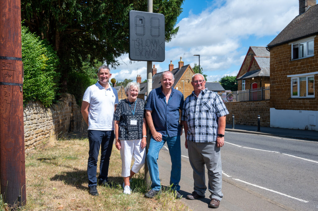 Parish councillors Jamie Dye, Sue Deane, Chris Payne and Malcolm Spalding next to the speed reduction sign Danielle’s oce helped to fund.