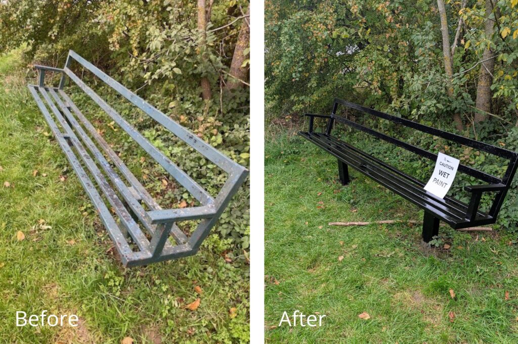 Side-by-side comparison of a metal bench before and after painting. The left image shows the bench in its original condition with a dull, weathered green finish. The right image shows the same bench freshly painted in glossy black, with a sign on the seat that reads “CAUTION WET PAINT.” Both benches are outdoors on grass, surrounded by trees and bushes.