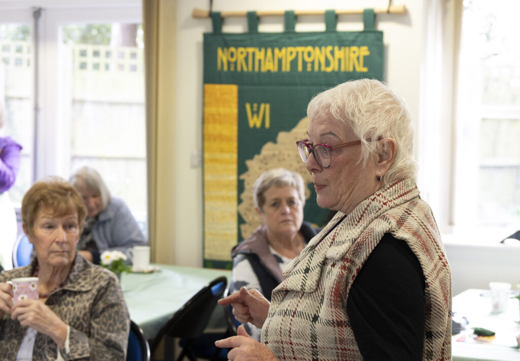 Commissioner indoors addressing a group of women